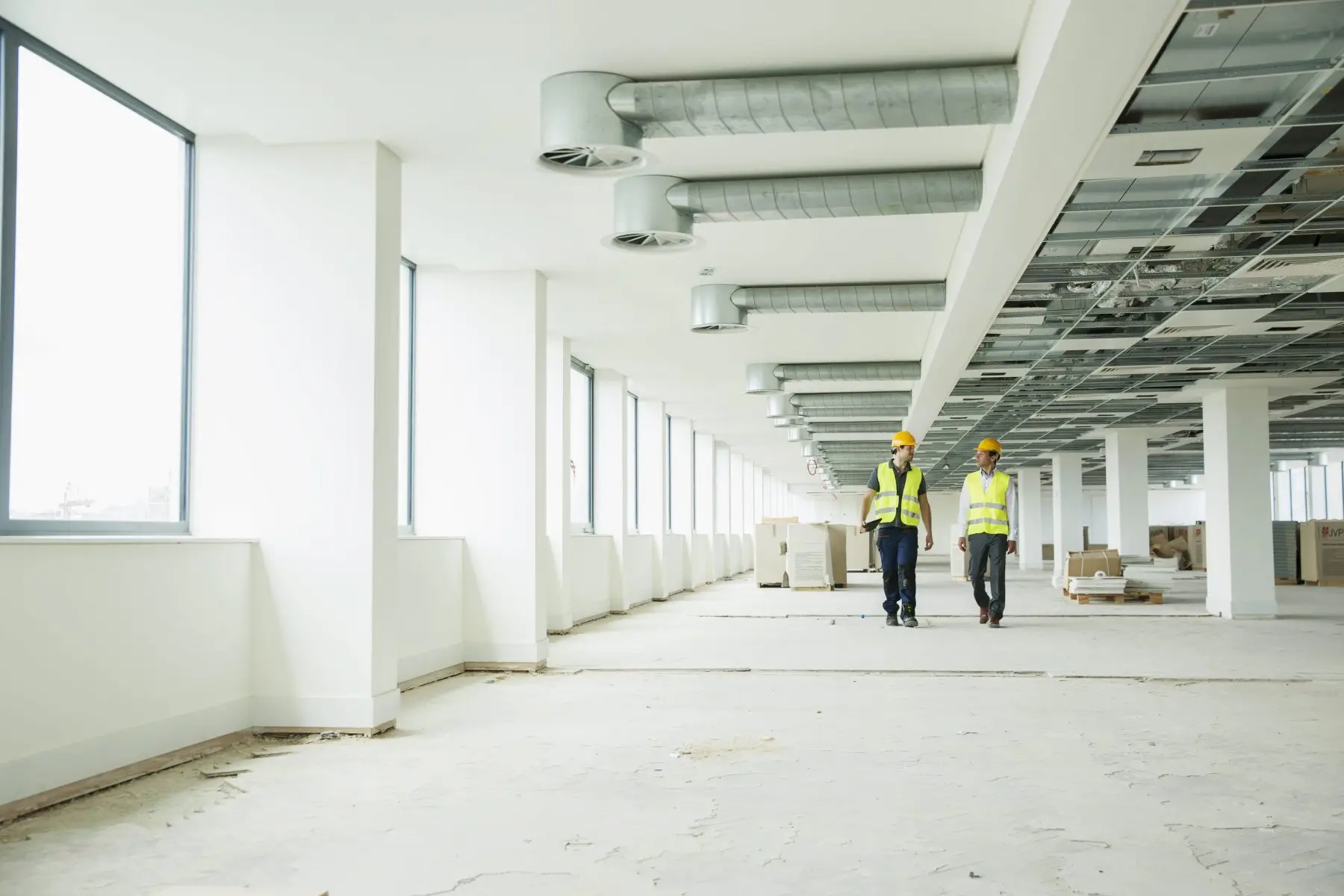Site team in hi-vis walking through a commercial refurbishment Welgo Builders Ltd Manchester